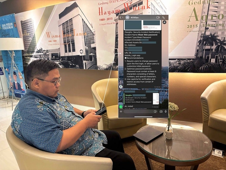 Bapak Hariyanto checking a security notification from the Sangfor Athena MDR team